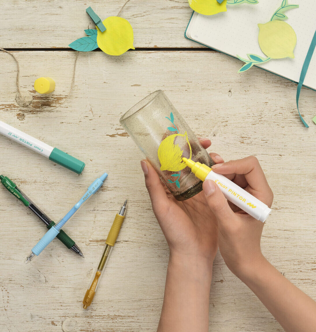 Pintor creative markers decorating glass cup with yellow lemons